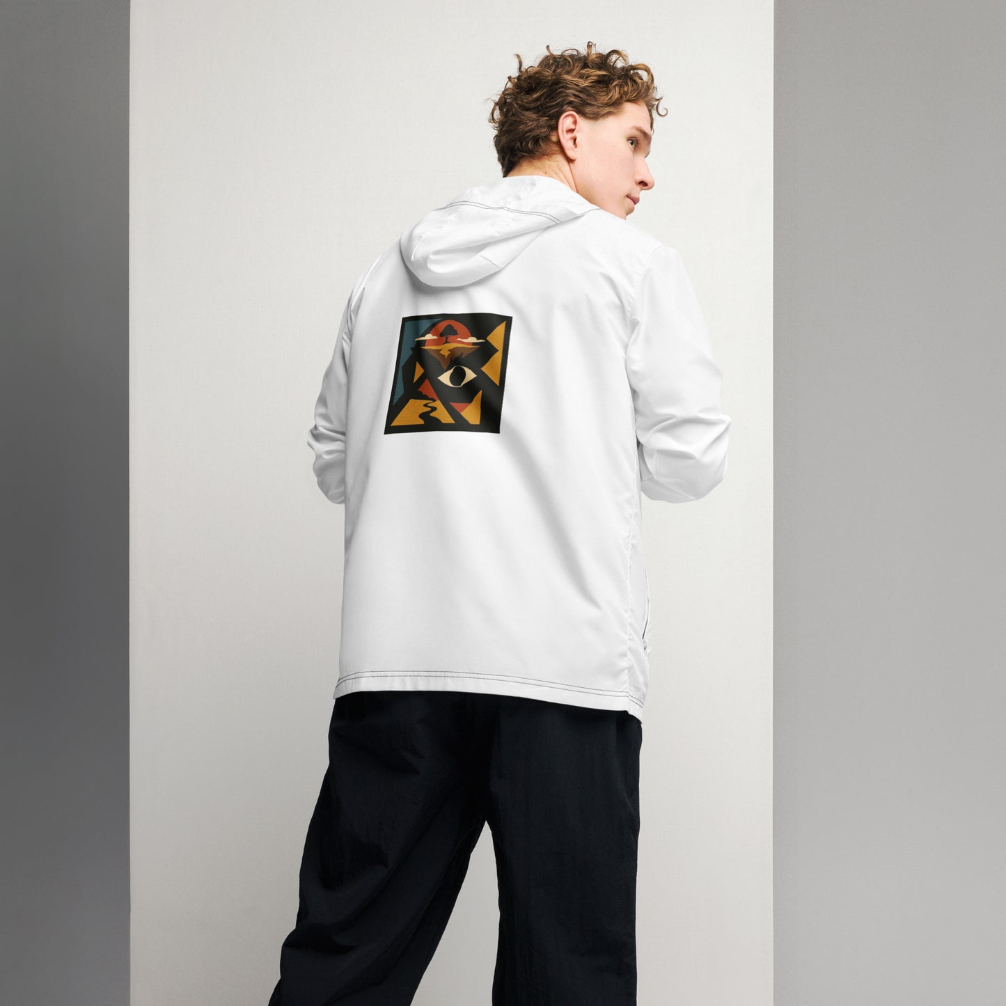 Person wearing a white hoodie with a colorful design on the back against a plain background