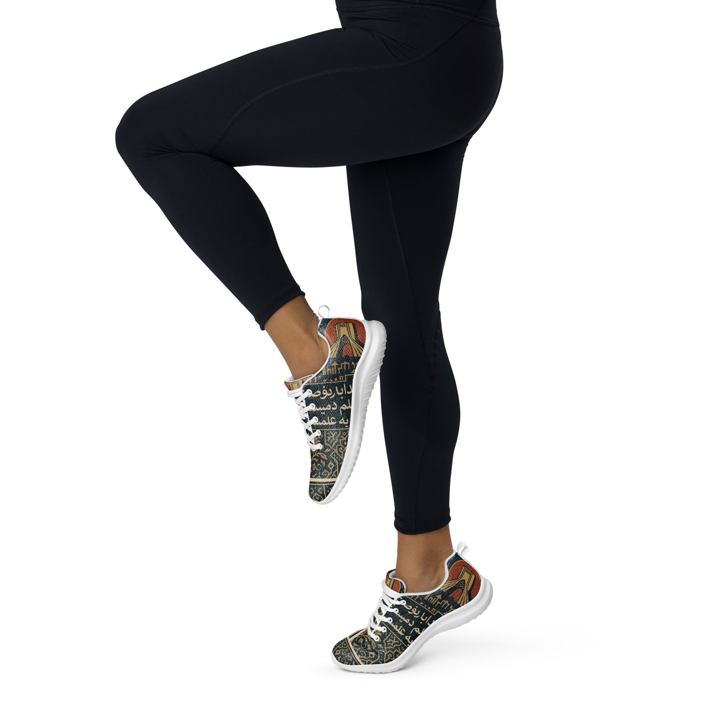 Persian wearing black leggings and patterned sneakers on a white background