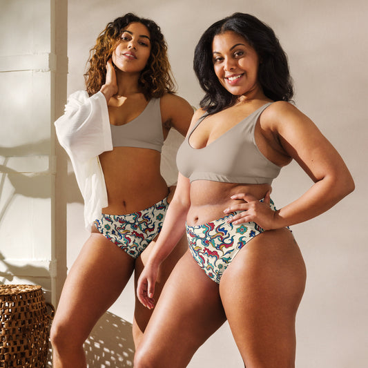 Two women wearing colorful floral bikinis standing side by side.