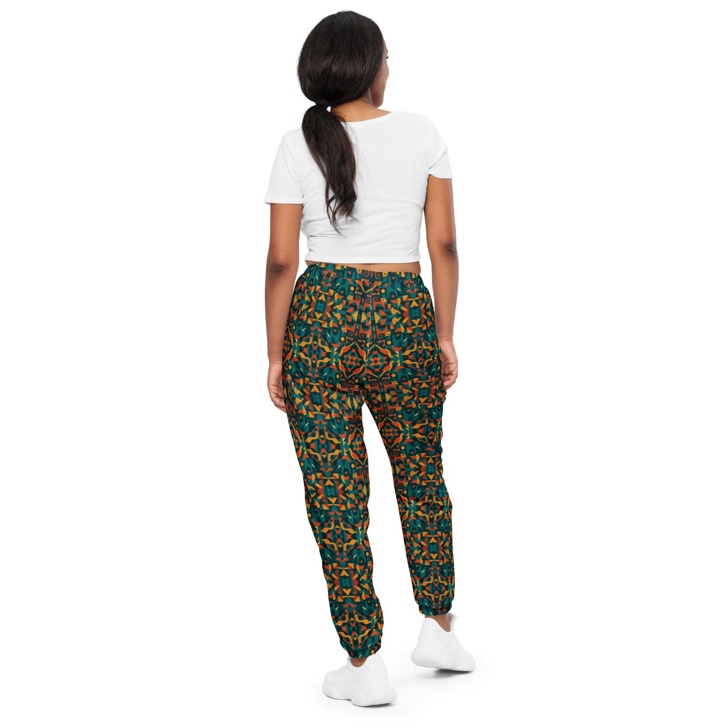 Person wearing a white crop top and patterned pants on a white background
