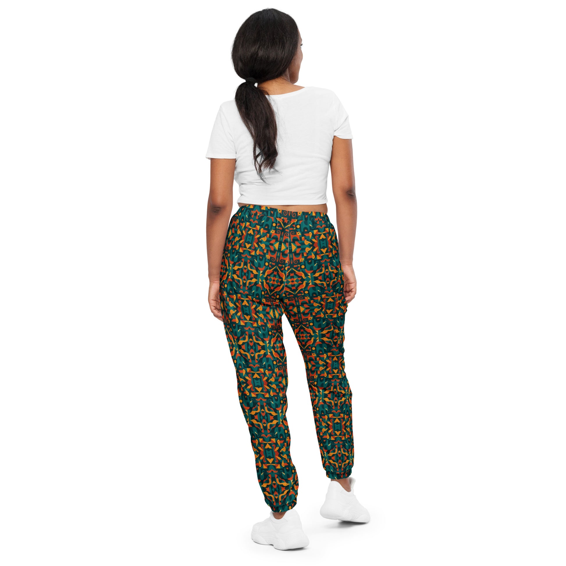 Person wearing a white crop top and patterned pants on a white background
