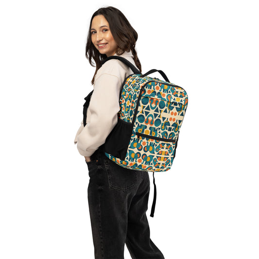Person wearing a colorful patterned backpack on a white background