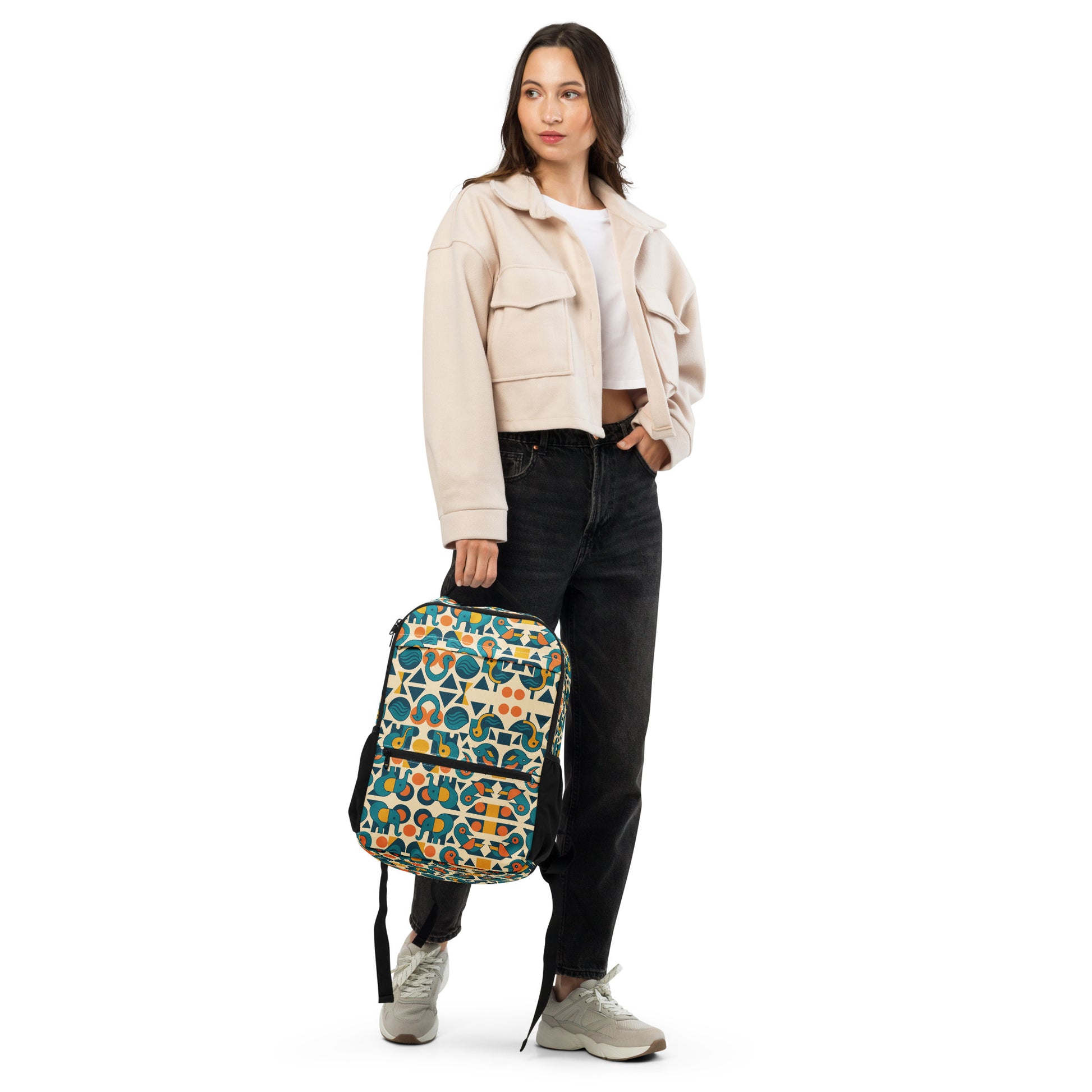 Woman holding a patterned backpack on a white background