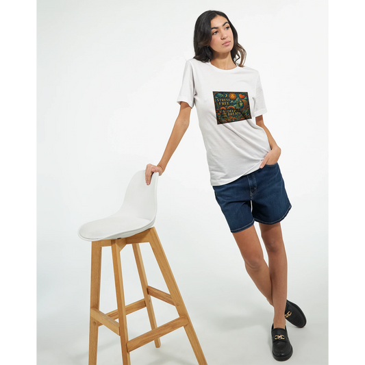 Woman wearing a white t-shirt with a graphic design, standing next to a white stool on a white background