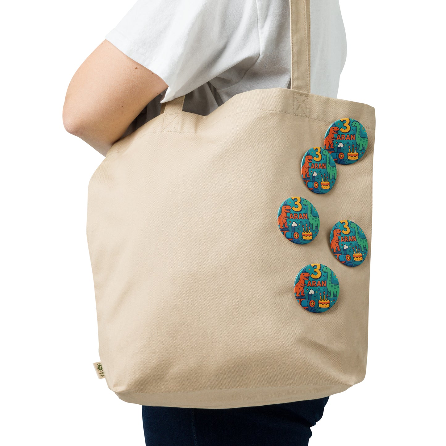 Beige tote bag with colorful buttons on a white background