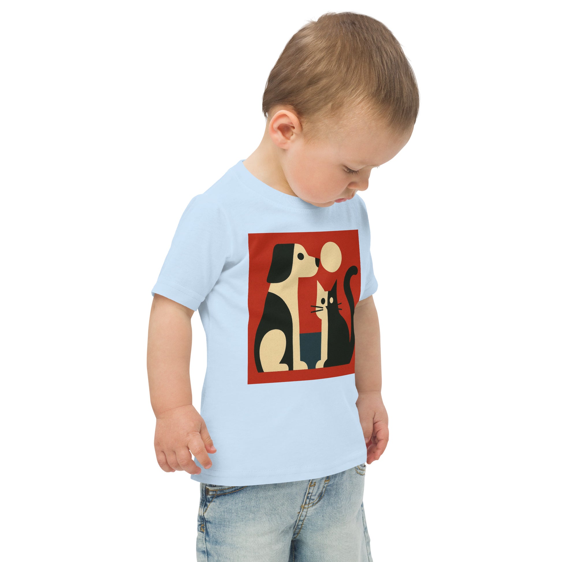 Child wearing a light blue t-shirt with a graphic design of two dogs and a mouse on a red background.