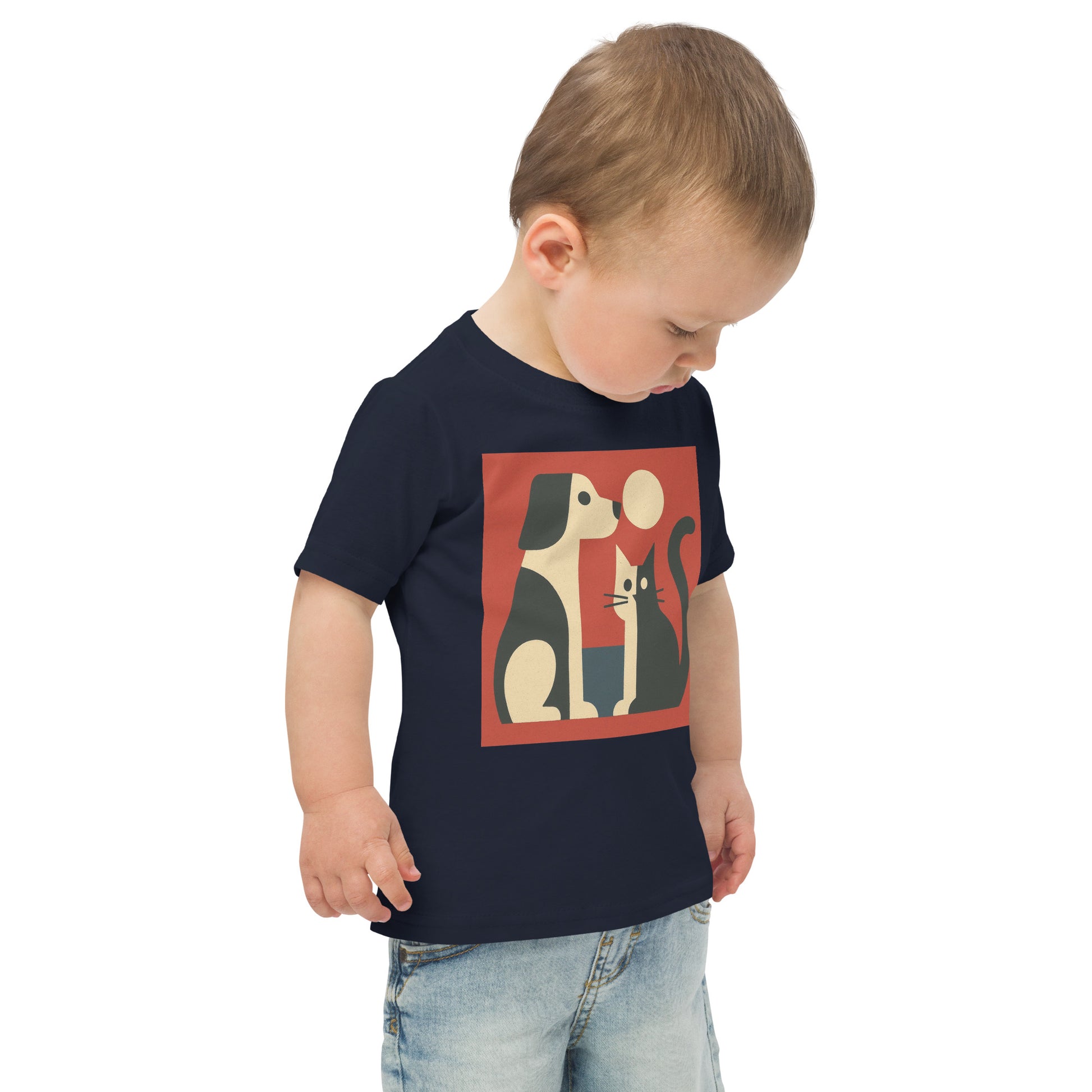 Child wearing a navy blue t-shirt with a graphic design of two cats and a mouse on a white background