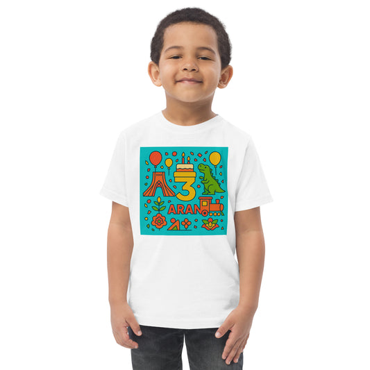 Child wearing a white t-shirt with colorful birthday design on a white background