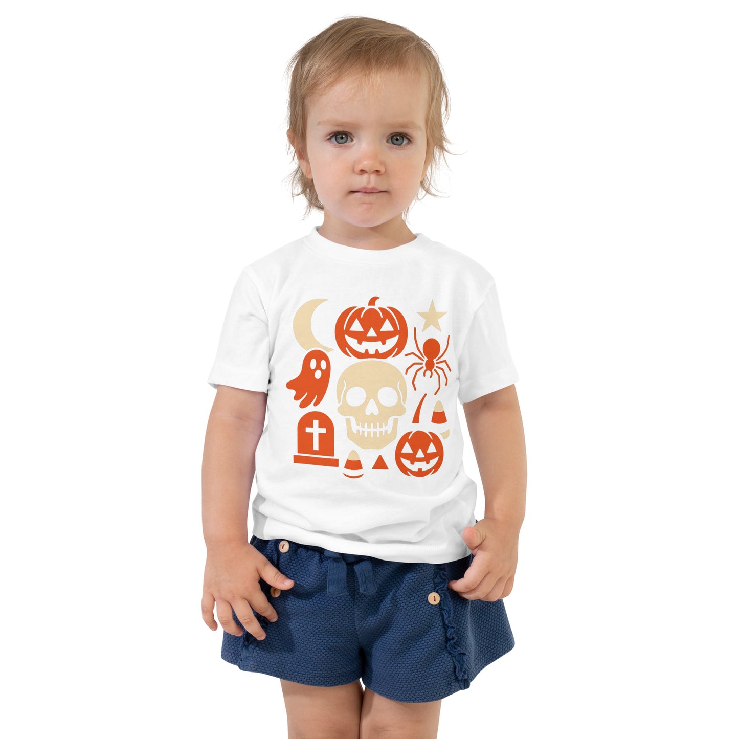 Child wearing a white t-shirt with Halloween-themed graphics on a white background