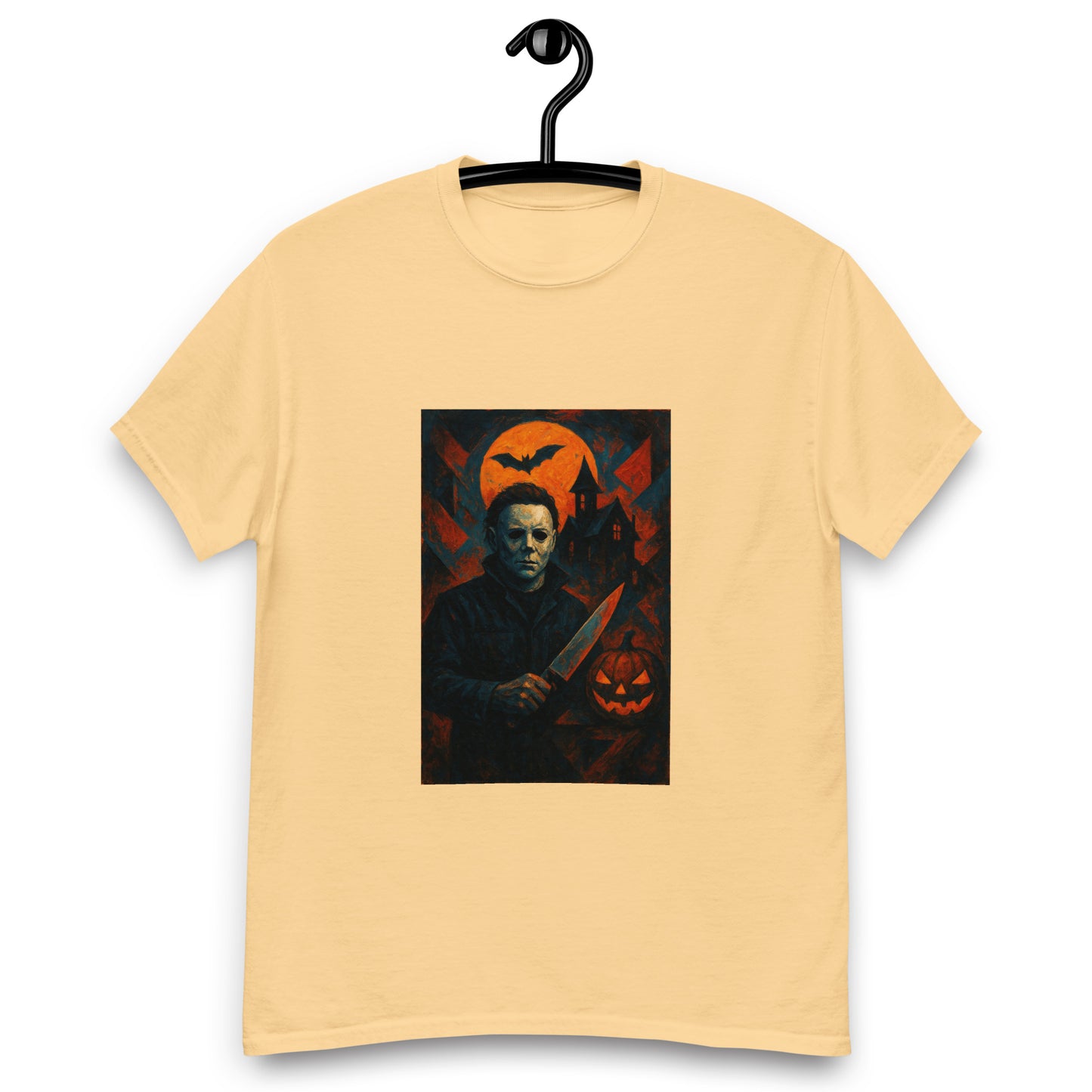 Beige t-shirt with a graphic of a character holding a knife and a pumpkin, on a hanger against a white background.