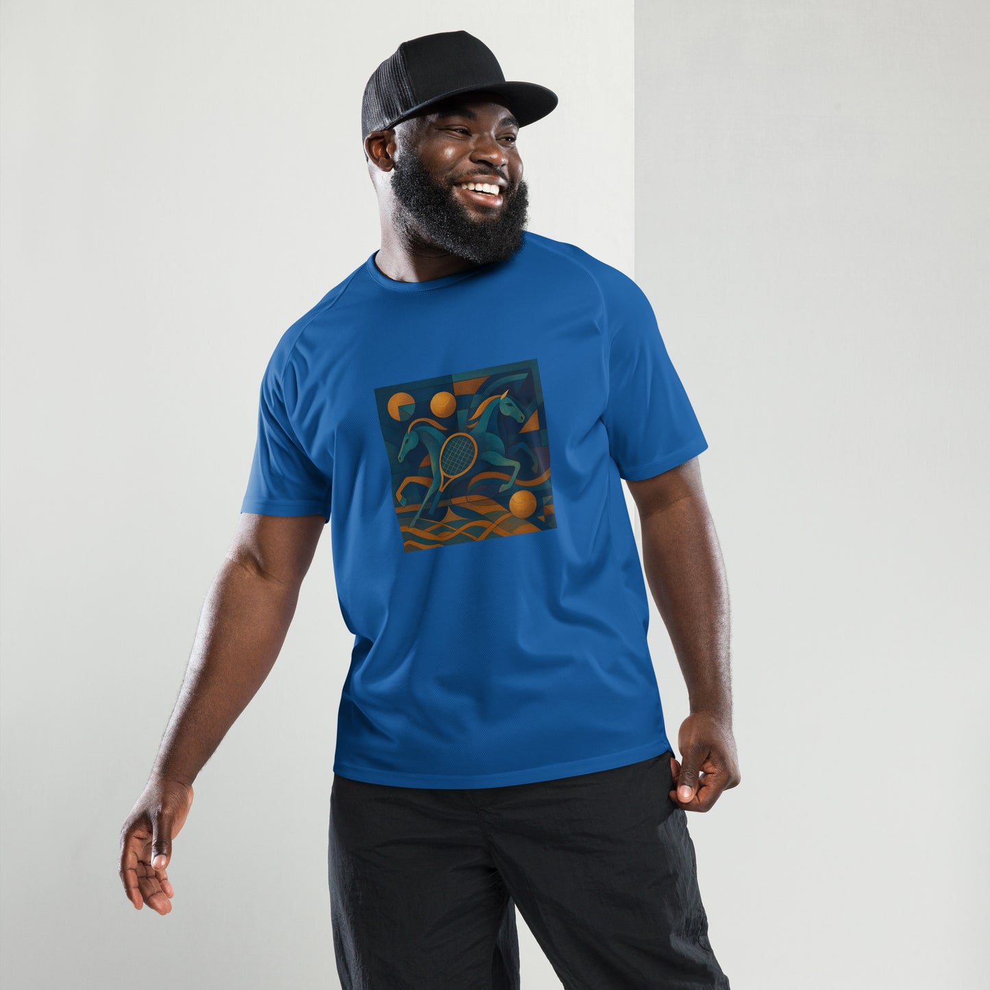 Man wearing a blue t-shirt with a colorful graphic design on a plain background