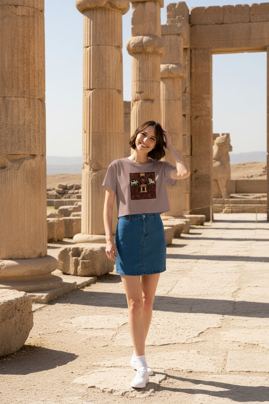 Woman wearing a brown t-shirt with a graphic design and a blue denim skirt on a white background