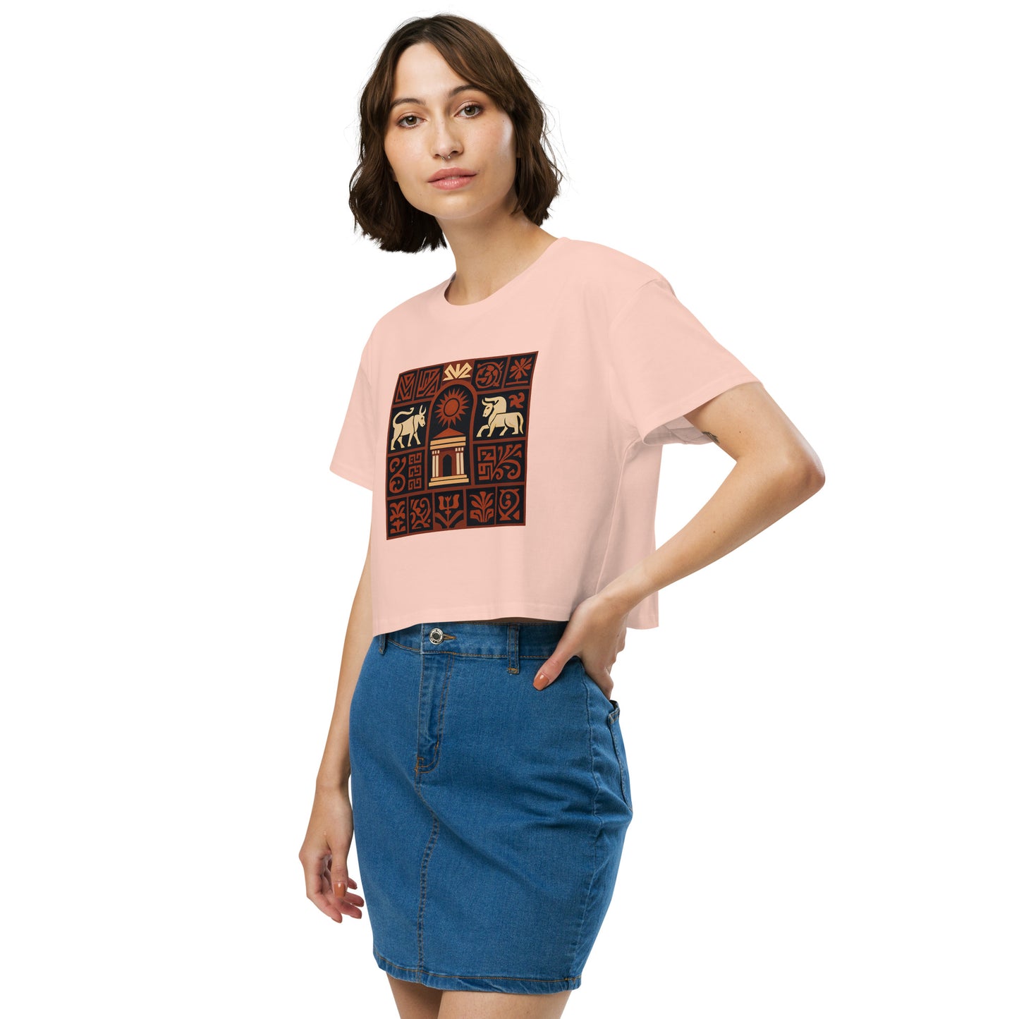Woman wearing a pink t-shirt with a graphic design and a blue denim skirt on a white background